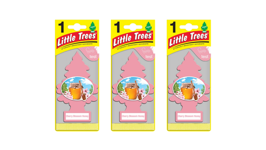 Three packages of Little Trees air fresheners on a white background