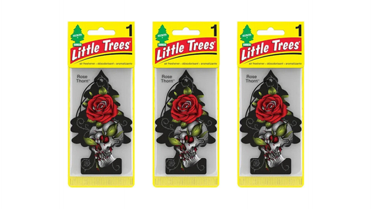 Three packages of Little Trees air fresheners with floral designs on a white background
