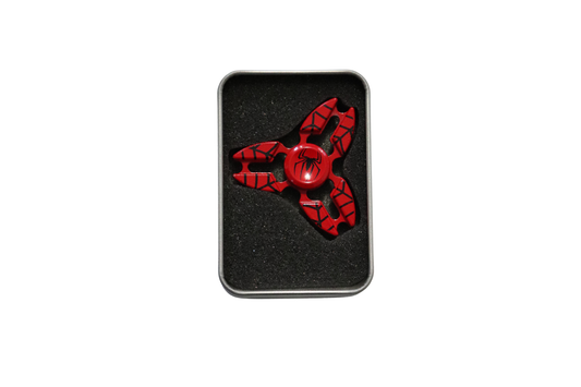 Red and black fidget spinner in a tin box on a white background