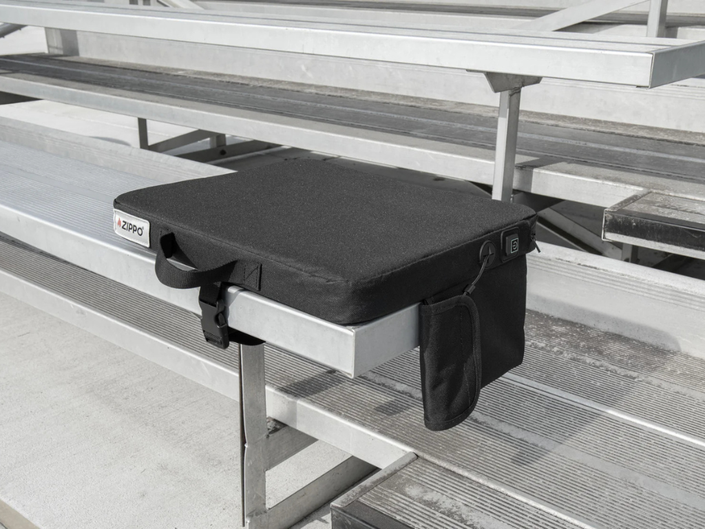 Black Zippo heated seat outside on a metal bleacher
