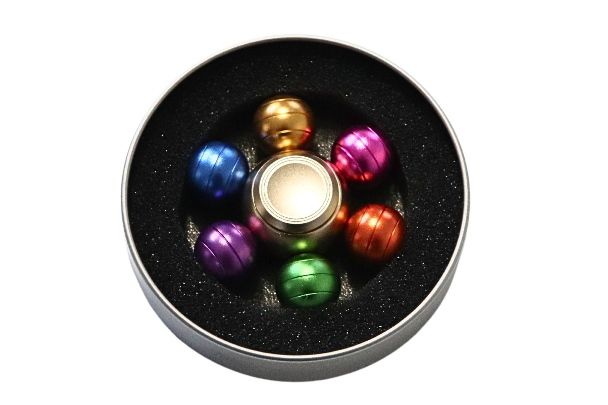 Colorful fidget spinner in a black container on a white background