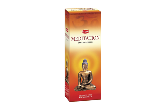 Box of HEM Meditation incense sticks with a Buddha statue on an orange background