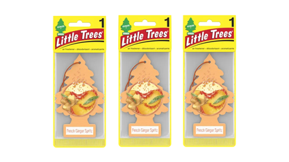 Three packages of Little Trees with peach ginger spritz scent on a white background