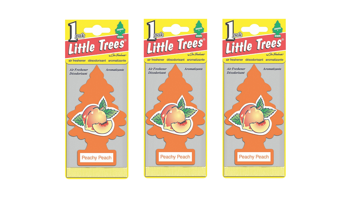 Three packages of Little Trees Dandy Peach air fresheners on a white background
