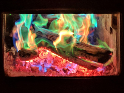 Colorful flames burning in a fireplace with glowing embers.