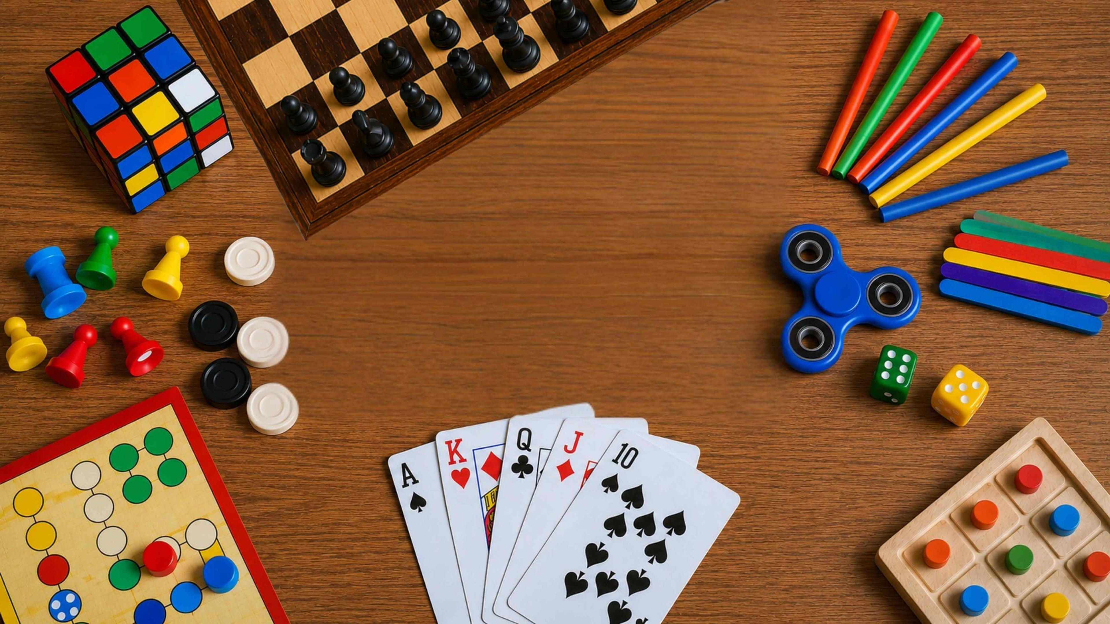 Collection of board games and toys on a wooden surface