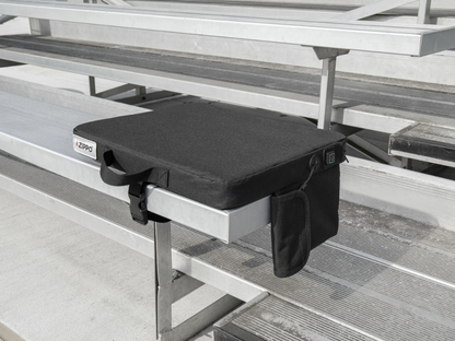 Black Zippo heated seat outside on a metal bleacher